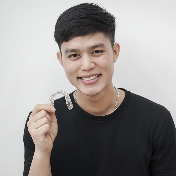 A boy with Invisalign smiling